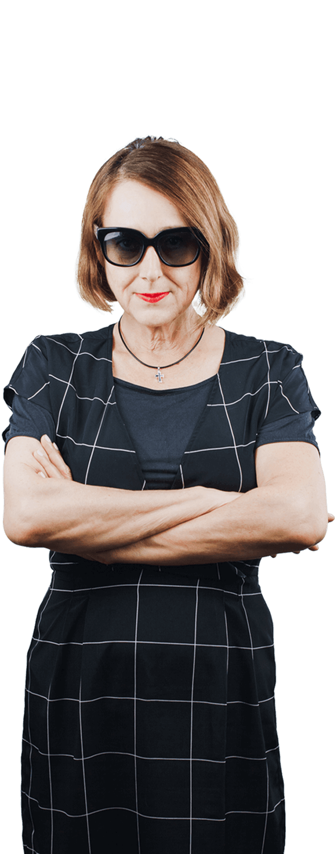 A serious looking Caucasian woman in her 50's with honey brown hair colour wearing sunglasses and grid dress