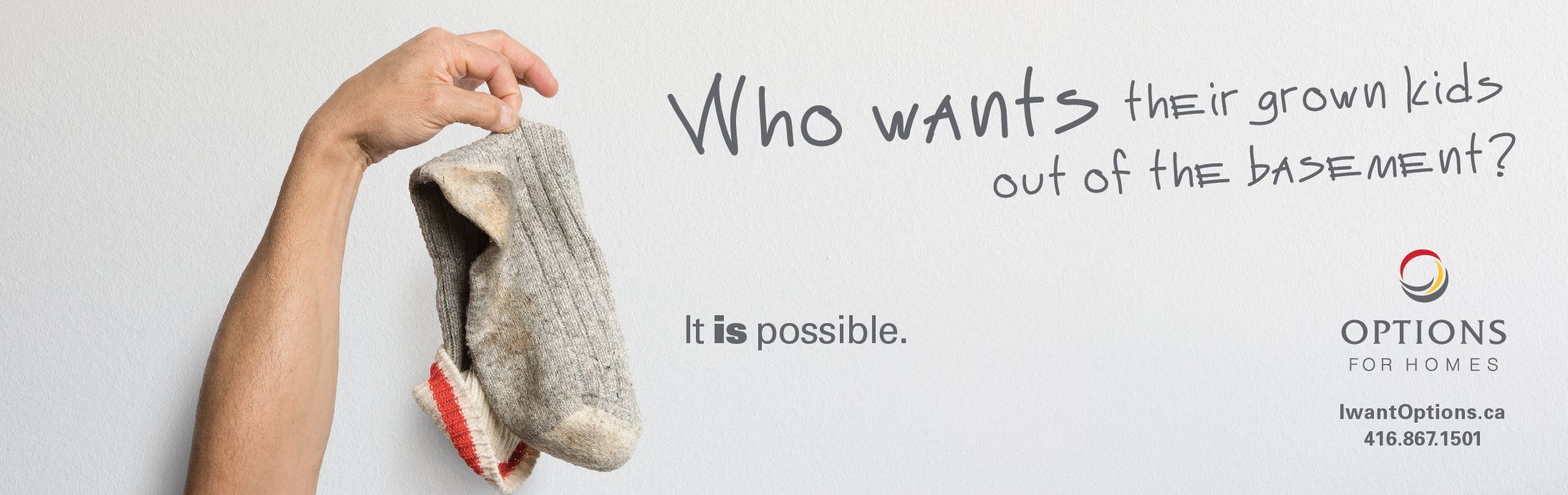 A man's hand holding up a dirty grey sock against a white background with the grey capitalize text 