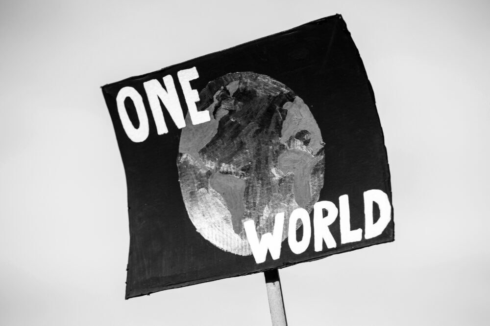 Black and white image of One World protest sign